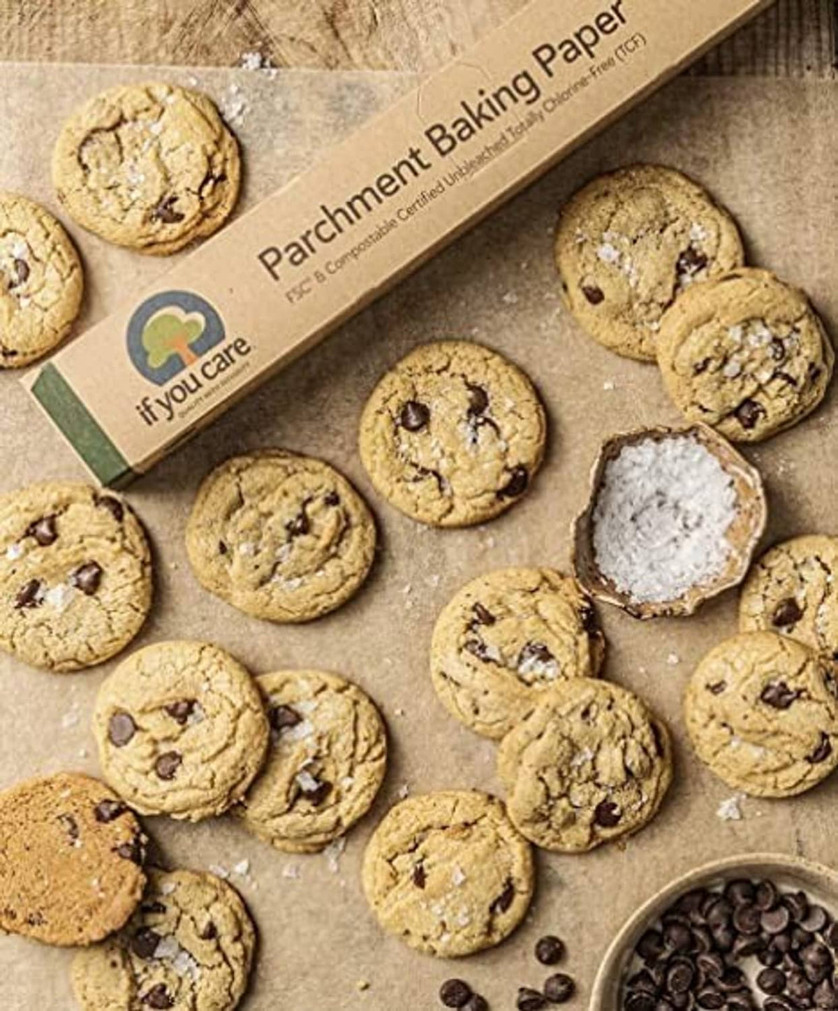 Parchment baking paper sheet with assorted cookies and parchment paper box