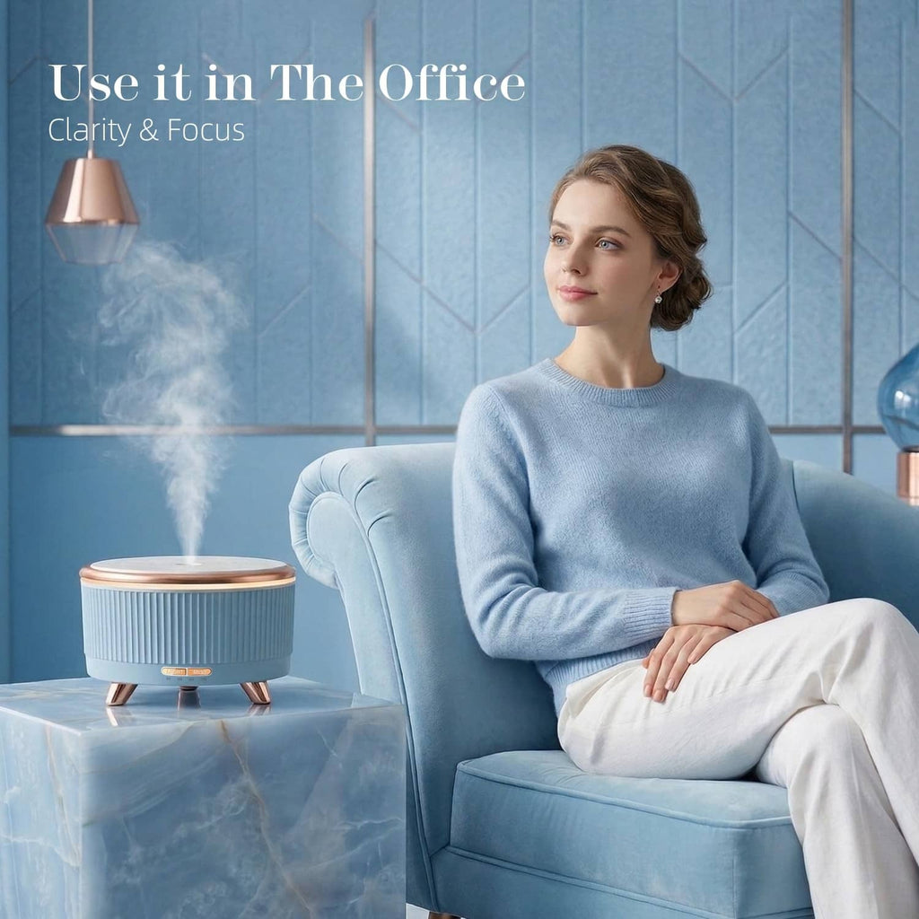 Blue ultrasonic essential oil diffuser on a side table, emitting a visible mist plume.