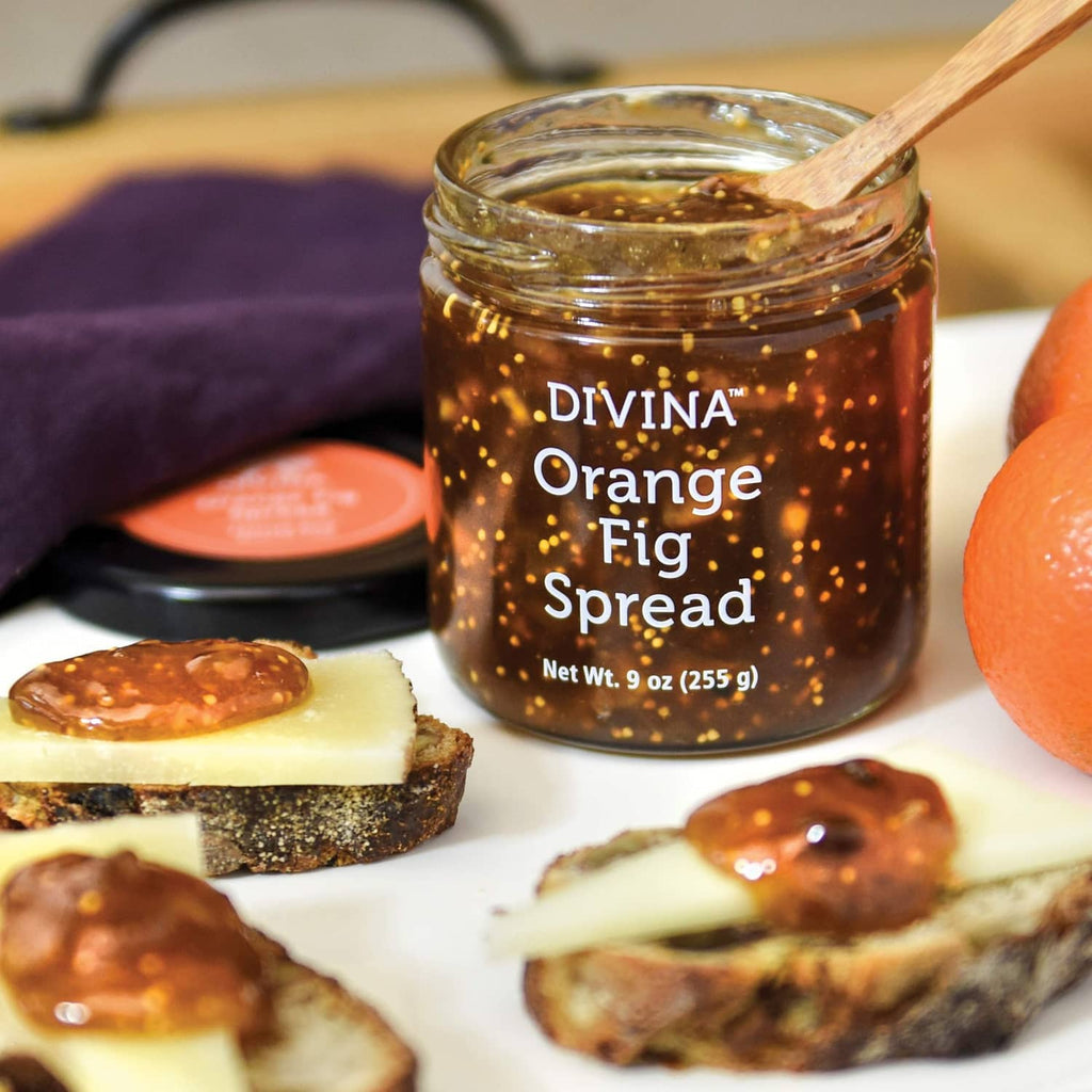 DIVINA Orange Fig Spread jar with wooden spoon and toast slices topped with jam