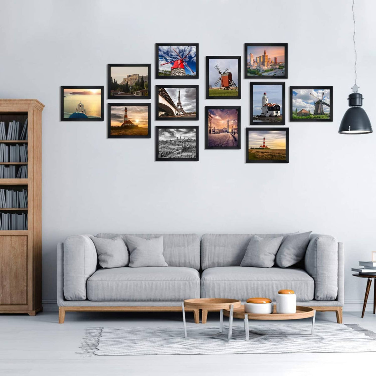 Black 8x10 photo frames arranged on a wall above a sofa