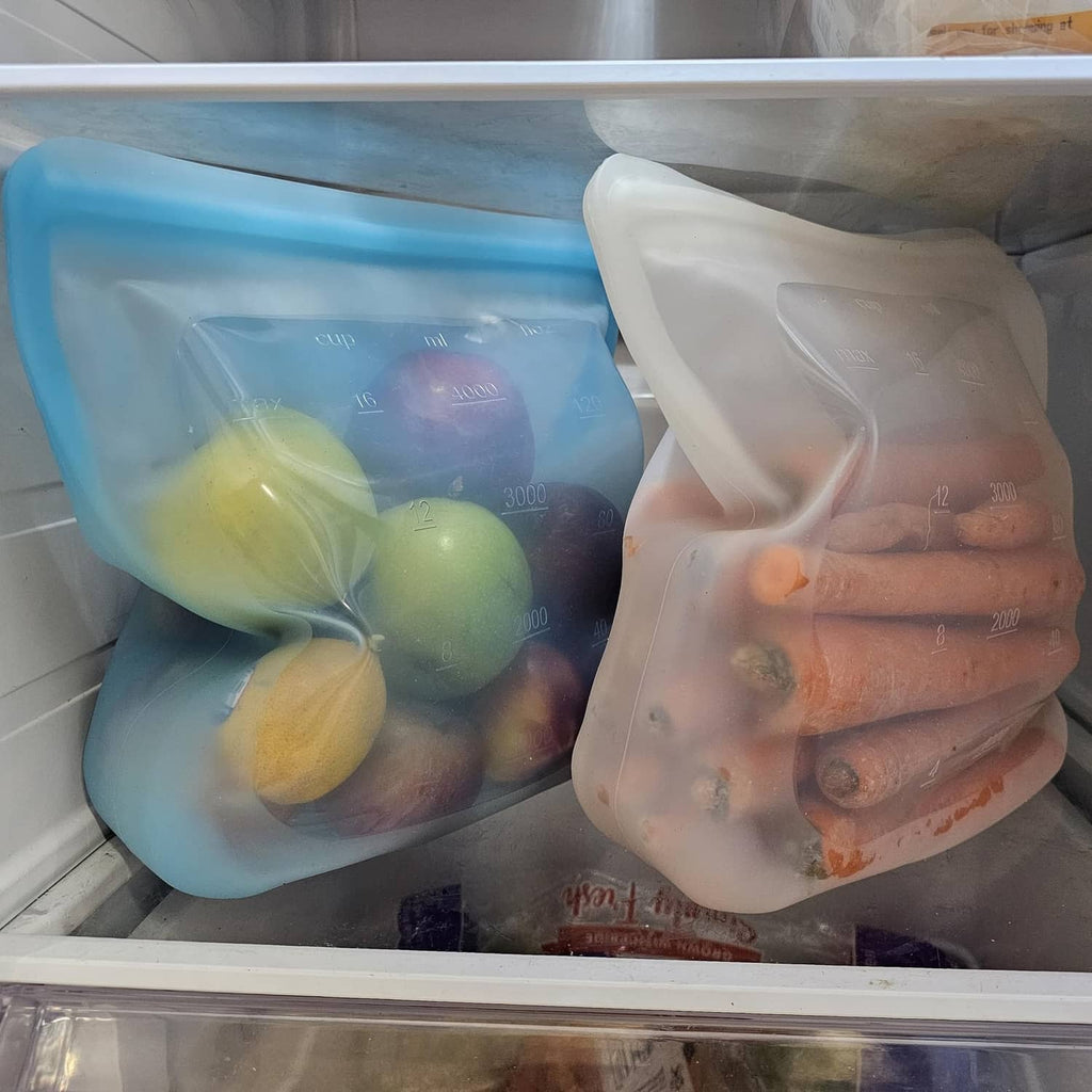 Freezer silicone bags: blue pouch with fruit and clear pouch with carrots