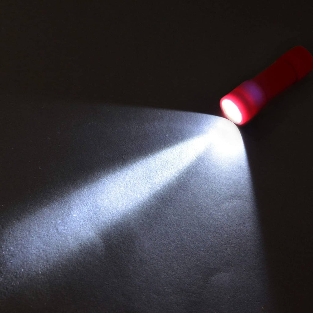 Red LED mini flashlight casting a bright light beam on a surface