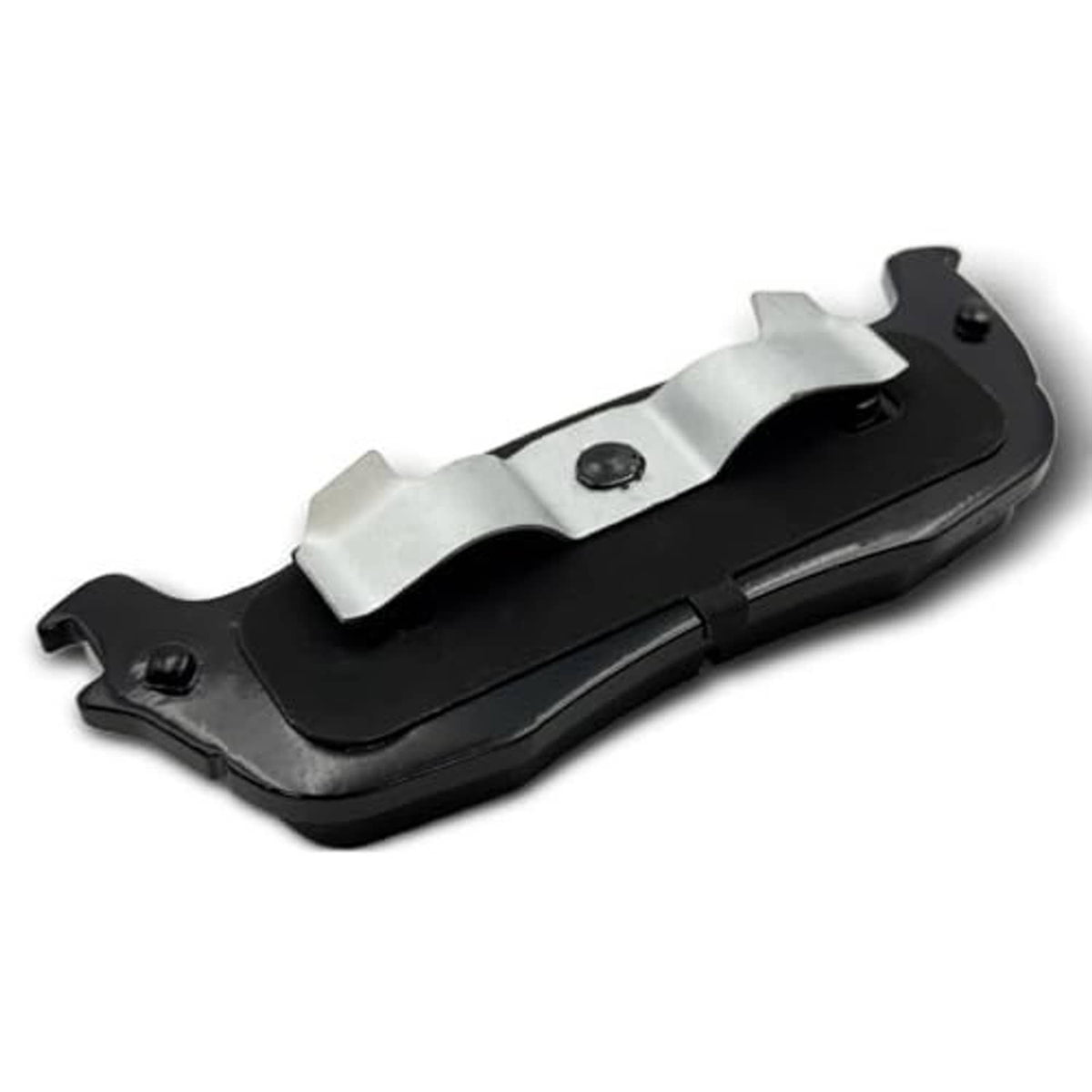 Ceramic brake pad underside view with black backing, metal clips, and bolt holes.