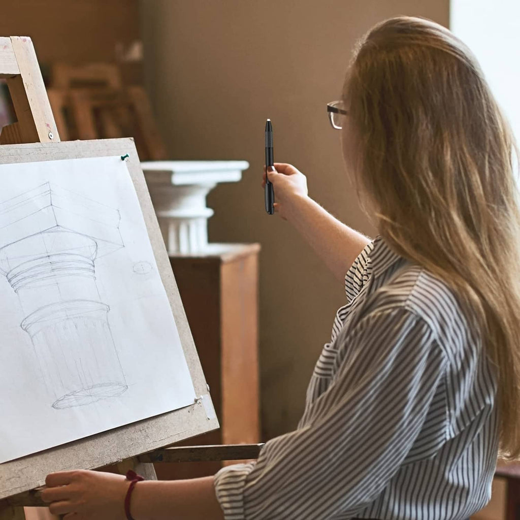 Retractable eraser mechanical pen held in hand while drawing on canvas