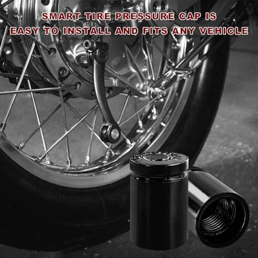 Black tire valve stem cap with threaded opening next to a car wheel rim.