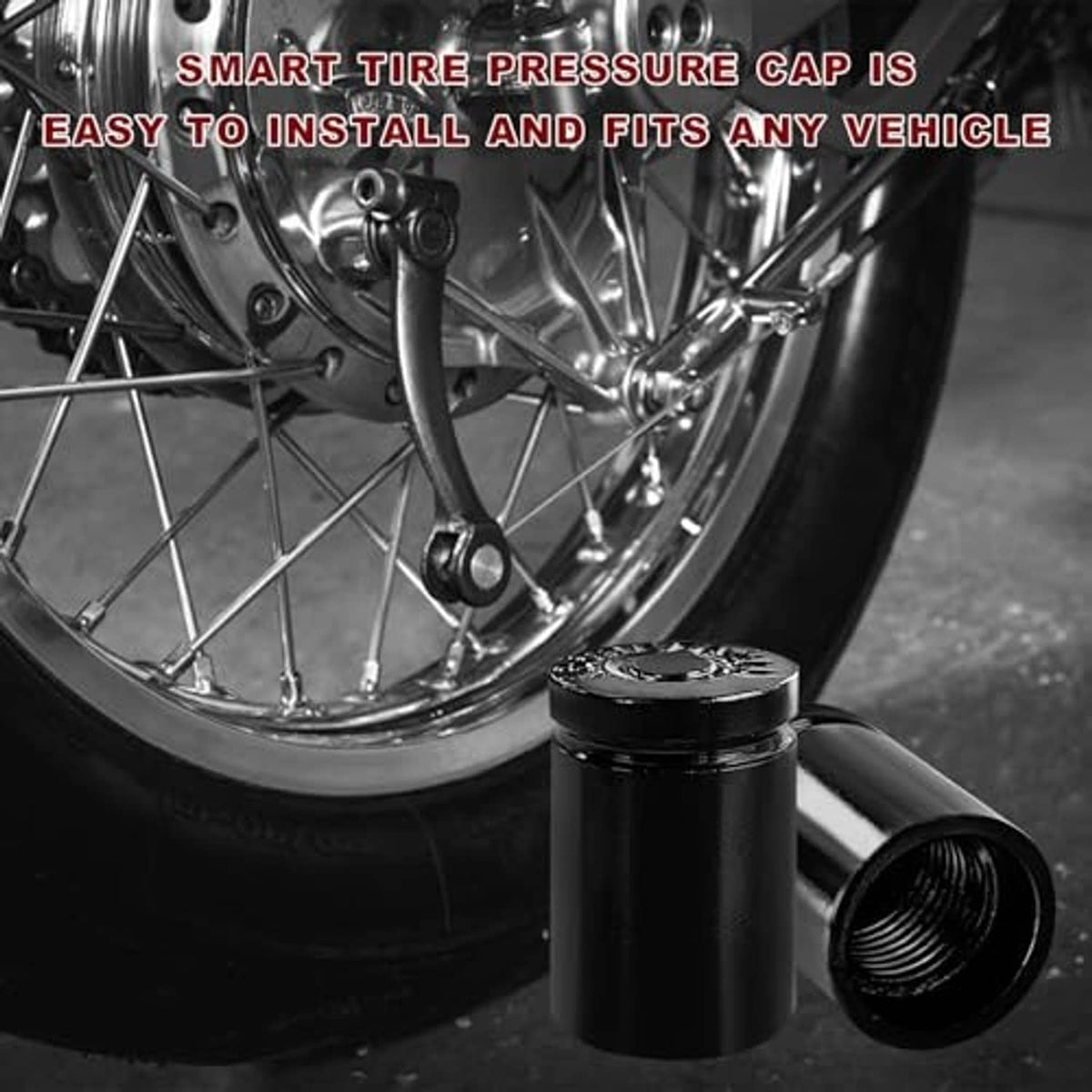 Black tire valve stem cap with threaded opening next to a car wheel rim.