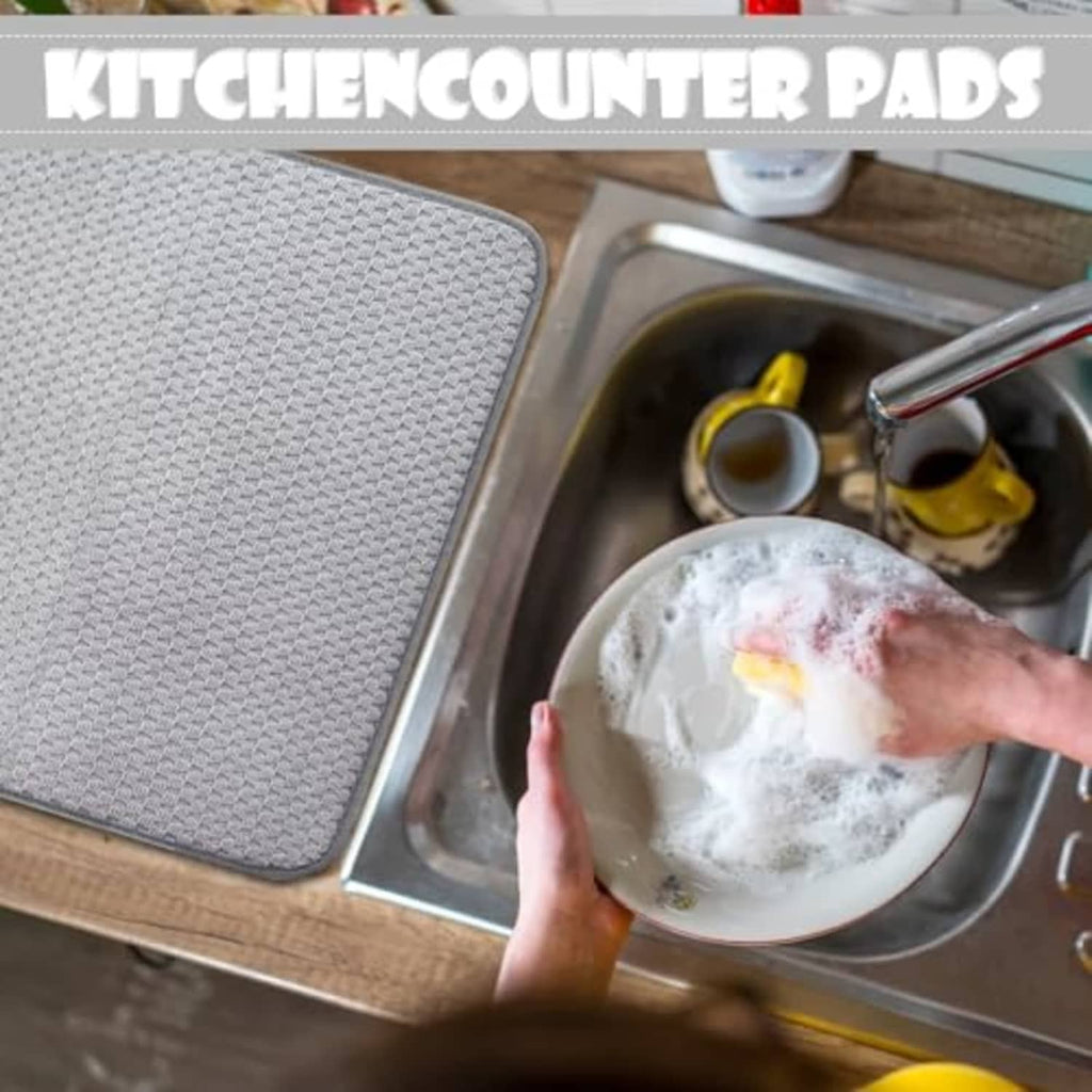 Gray microfiber dish-drying mat placed by kitchen sink; covers counter area beside dish bowl.