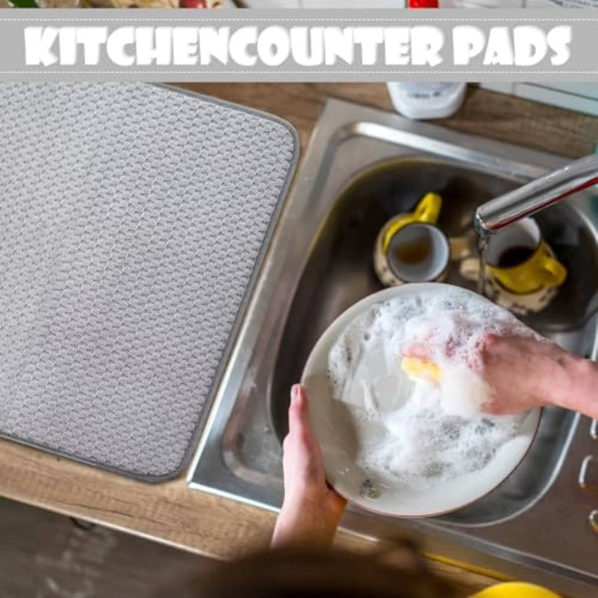 Gray microfiber dish-drying mat placed by kitchen sink; covers counter area beside dish bowl.