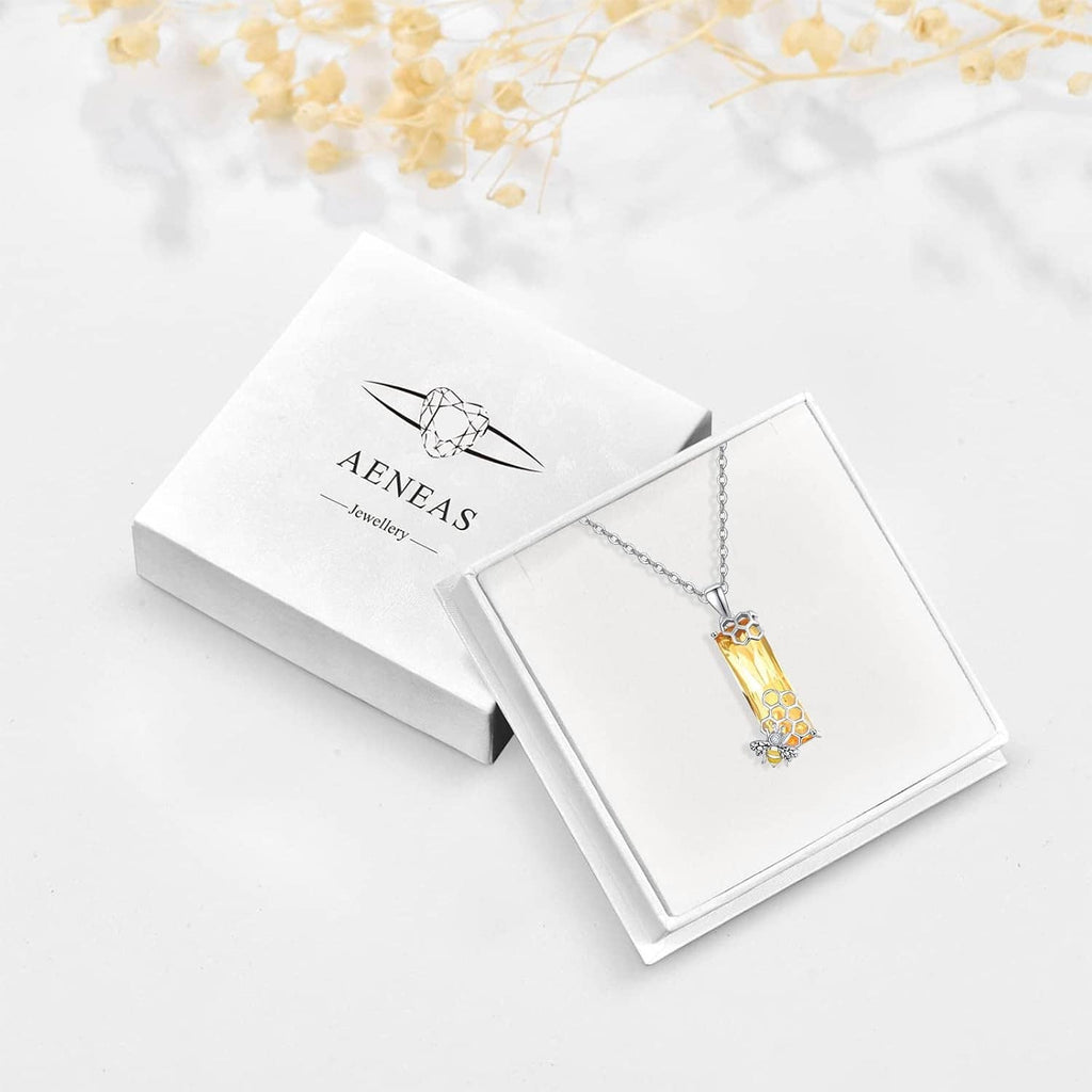 Necklace shown in gift box with silver chain and yellow honeycomb crystal pendant