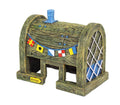 Wooden-look aquarium ornament with blue chimney, arched windows, and colorful bunting