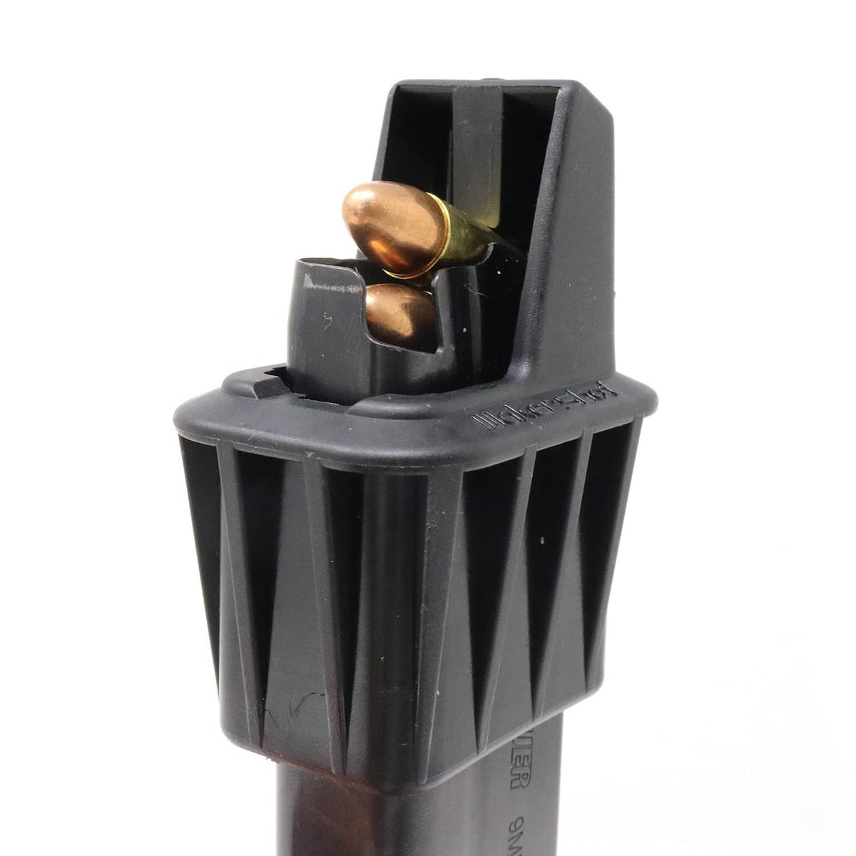 Black plastic speed loader with brass rounds in a top-loading magazine holder