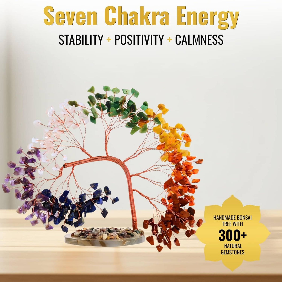 Seven chakra gemstone tree on round base with orange, purple, green, and blue crystals
