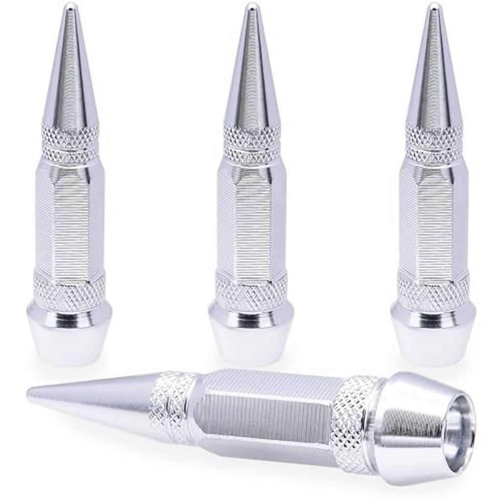 Four spiked aluminum tire valve stem caps, silver, three upright with one foreground