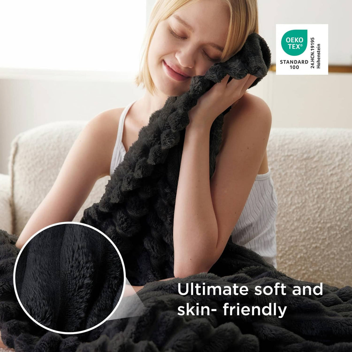 Black plush throw blanket held by a woman; close-up shows soft thick pile