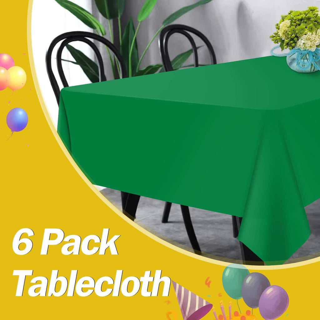 Green rectangular plastic tablecloth covering a table with neat fold and drape