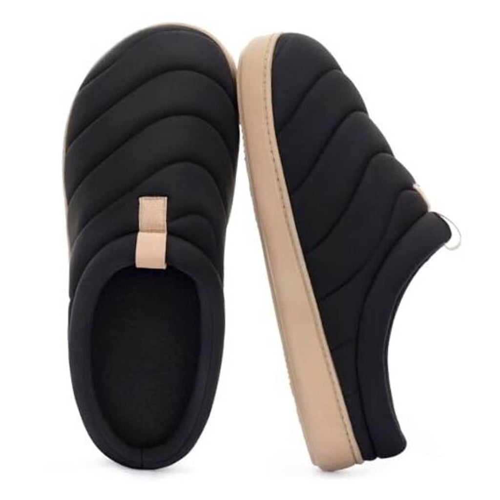 Black slip-on slippers showing quilted upper and beige outsole detail, front view.