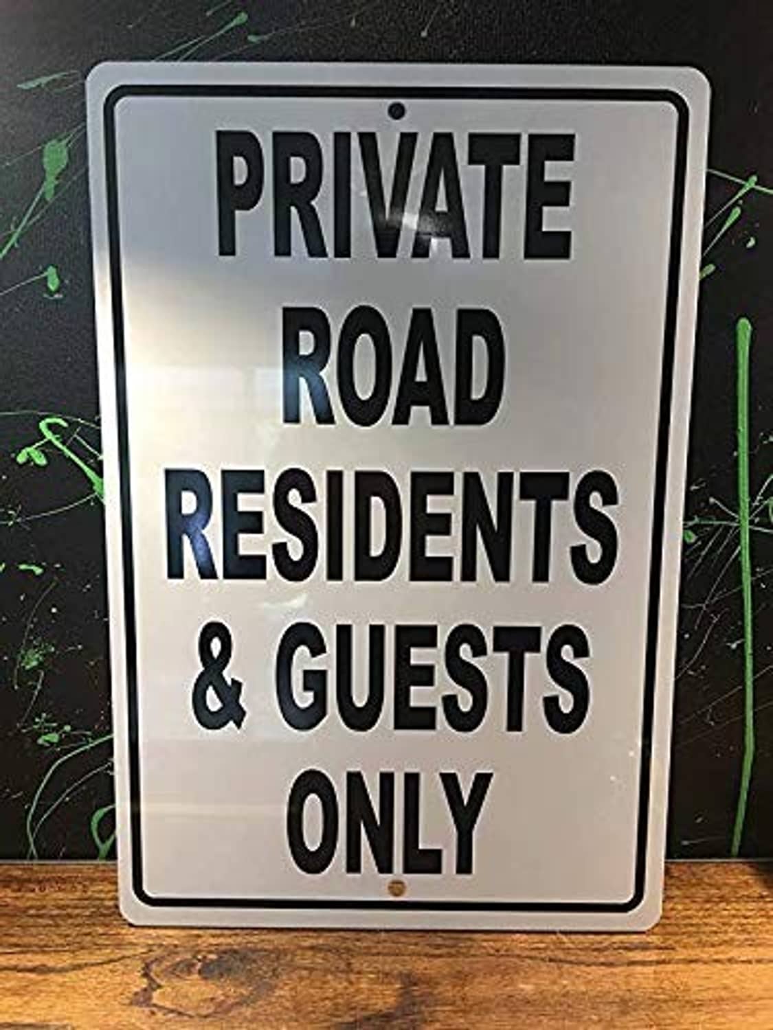 Aluminum road sign reading PRIVATE ROAD RESIDENTS & GUESTS ONLY