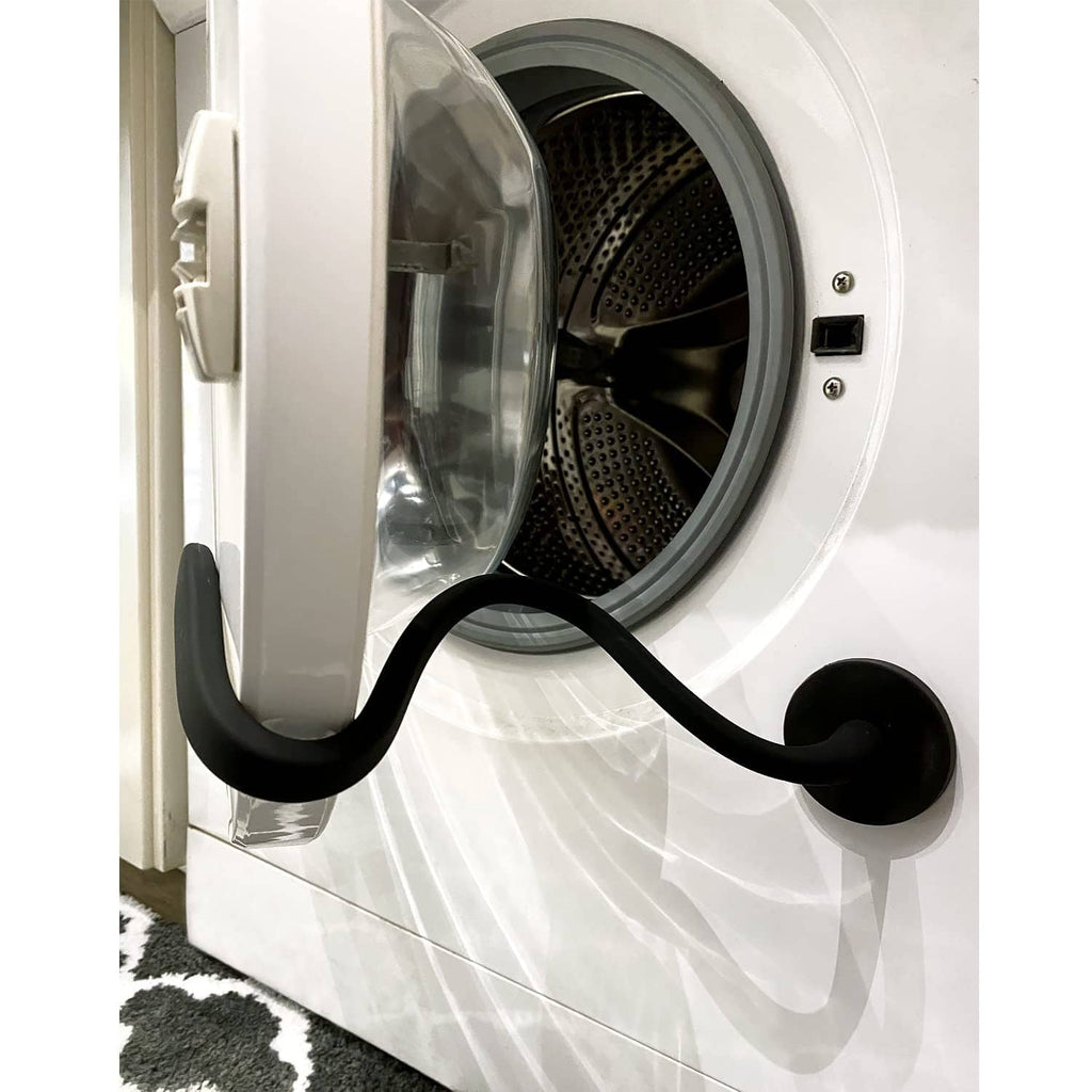 Black magnetic washer door prop holding open a front load washer door, flexible support