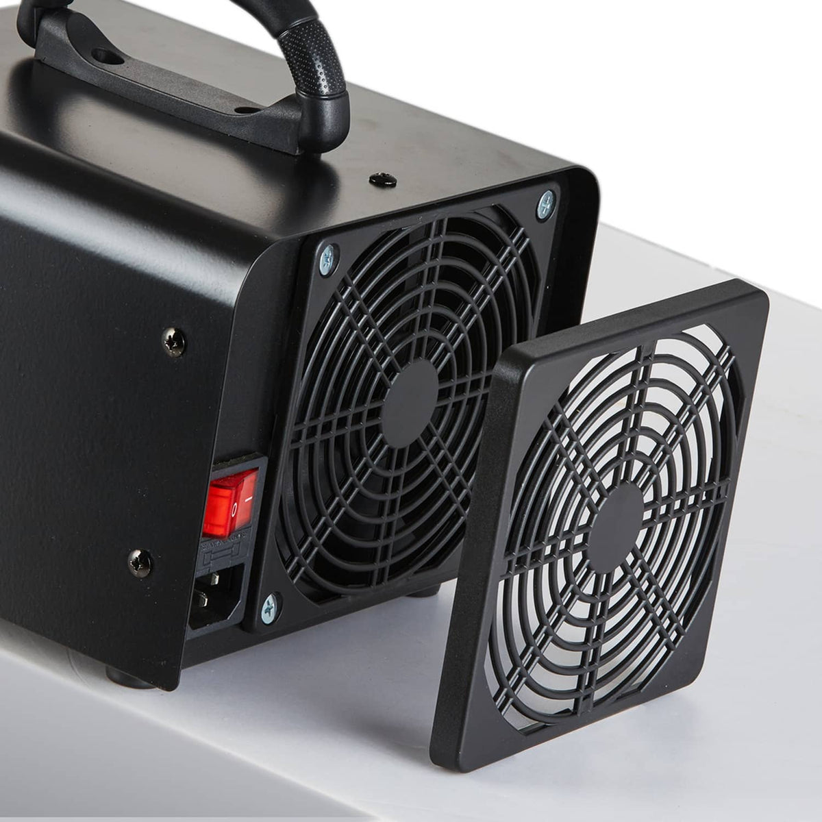 Close-up of black ozone generator machine fan intake with removable filter mesh