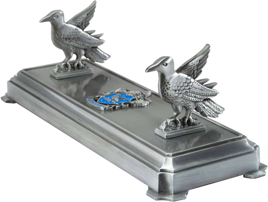 Silver metal wand stand with two raven figures and blue inlay, front three-quarter view