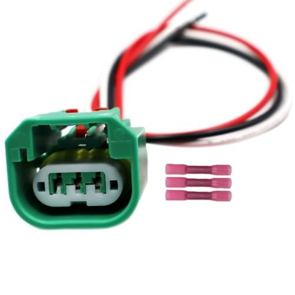 Green headlight connector harness with red/black wire leads and pink terminals