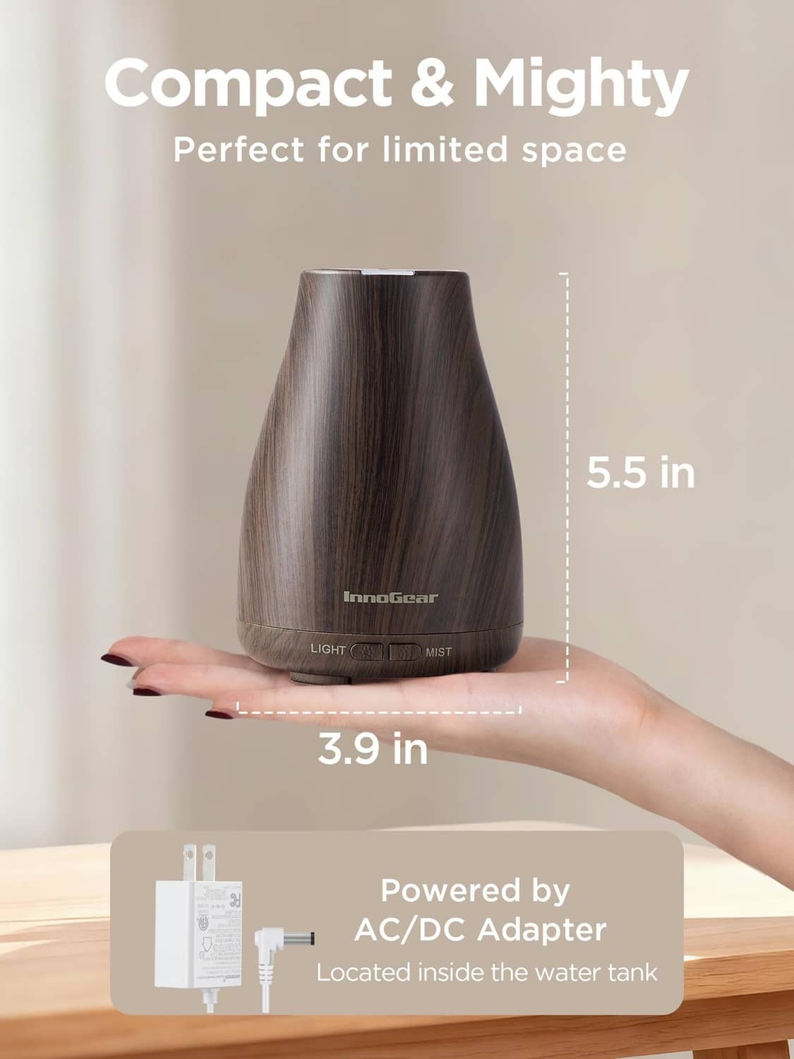 Compact brown ultrasonic essential oil diffuser on desk with light and mist buttons