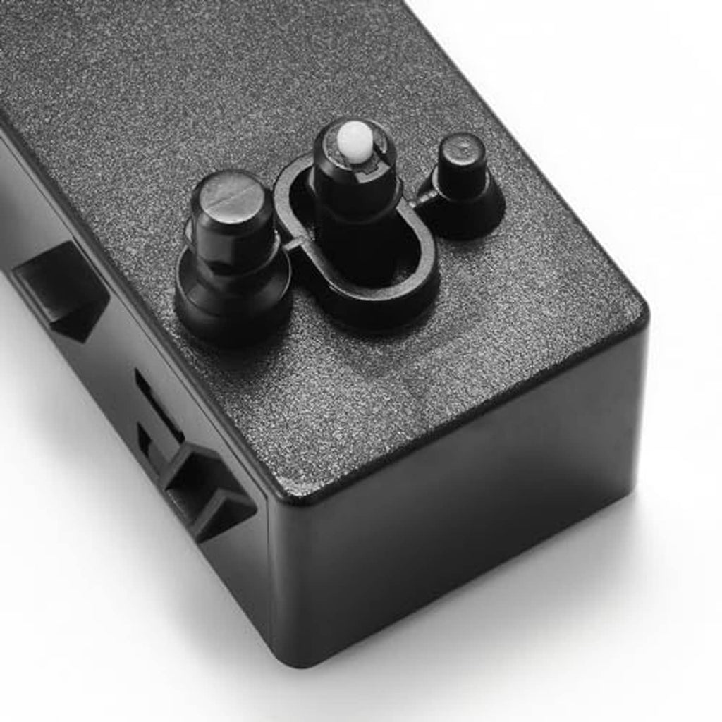Close-up of power seat switch buttons on gray textured panel and black housing