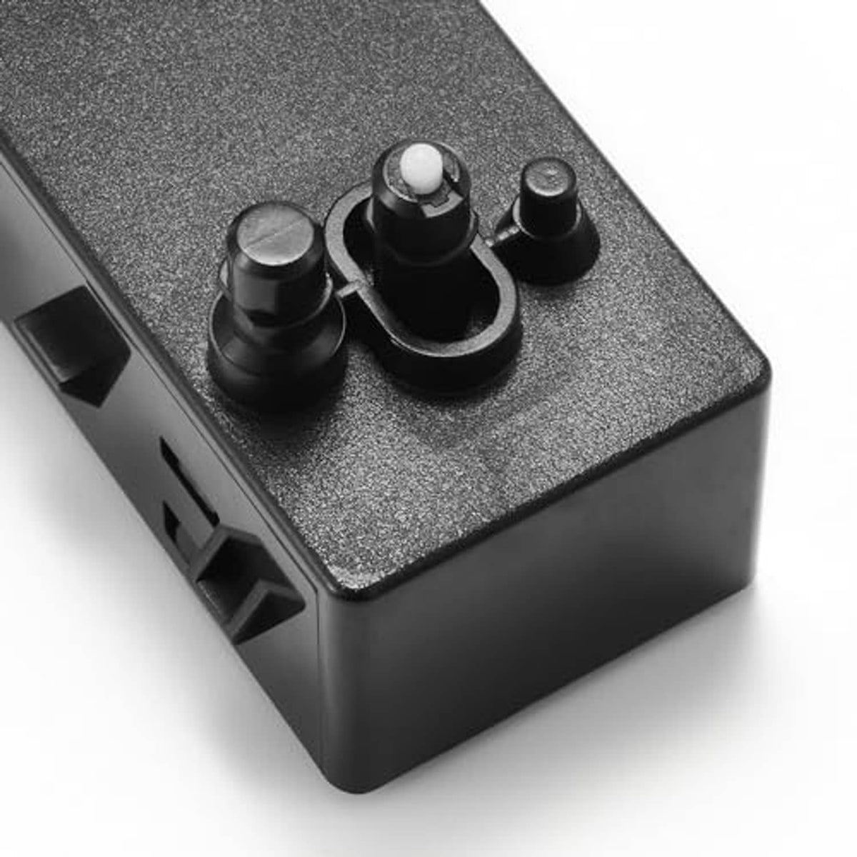 Close-up of power seat switch buttons on gray textured panel and black housing