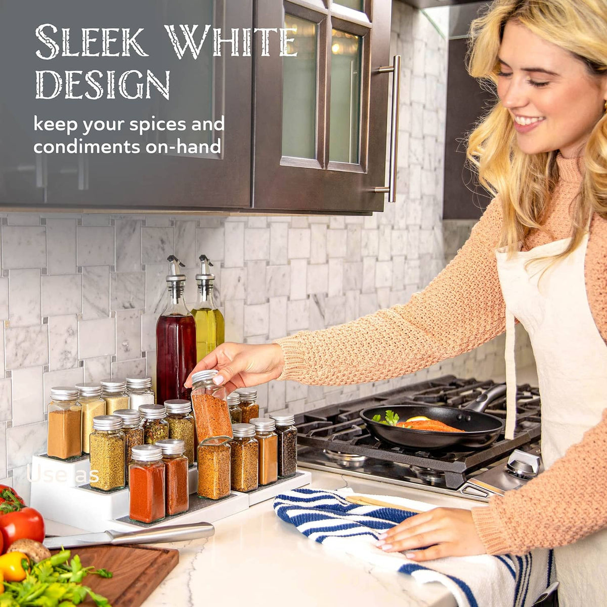 White expandable spice rack with gray trays holding spice jars beside the stove.