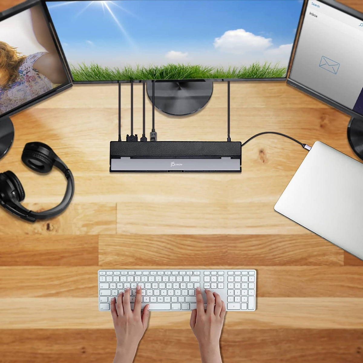 Black USB-C docking station on desk connecting dual monitors and accessories