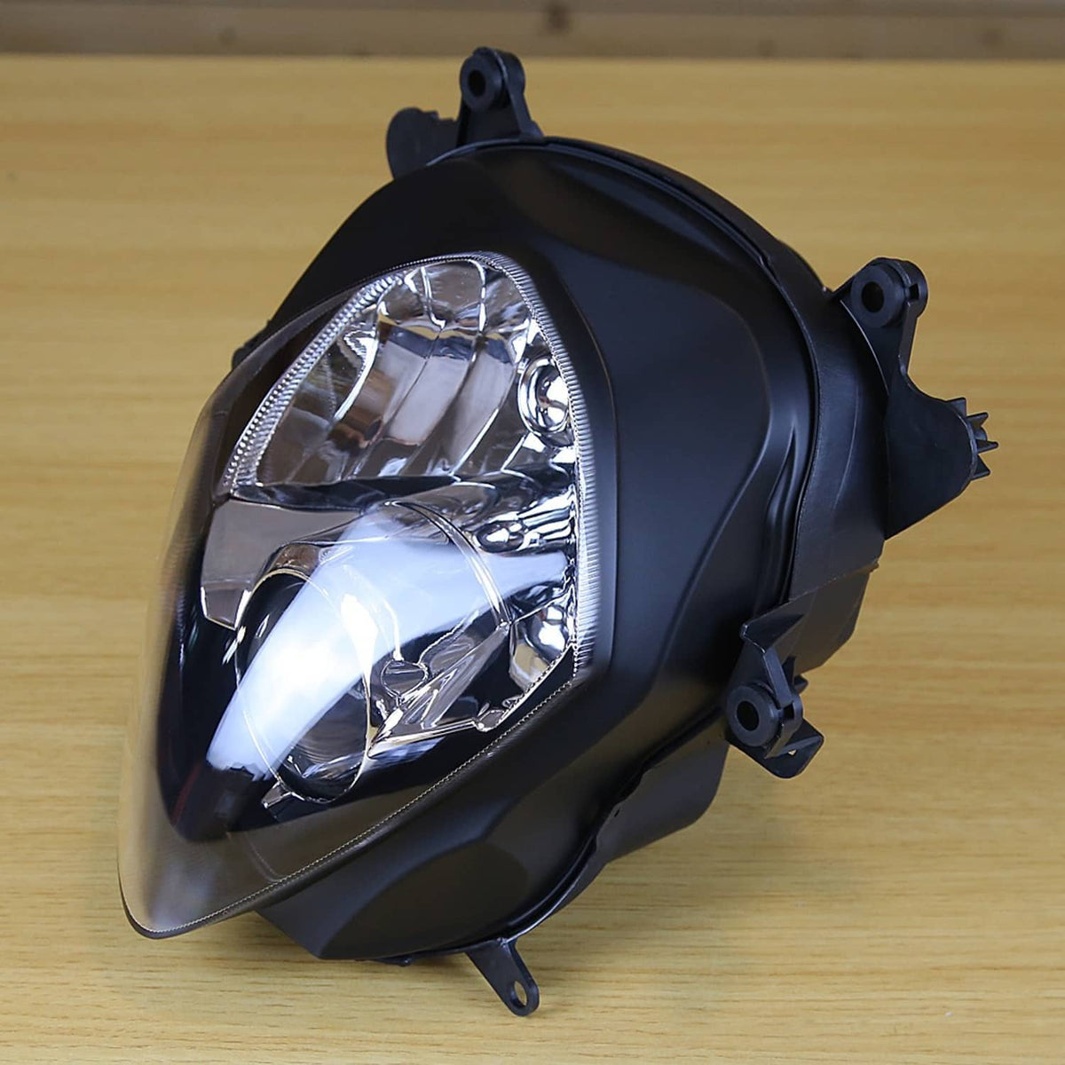 Front headlight assembly side view with clear reflector lens and black housing mount points