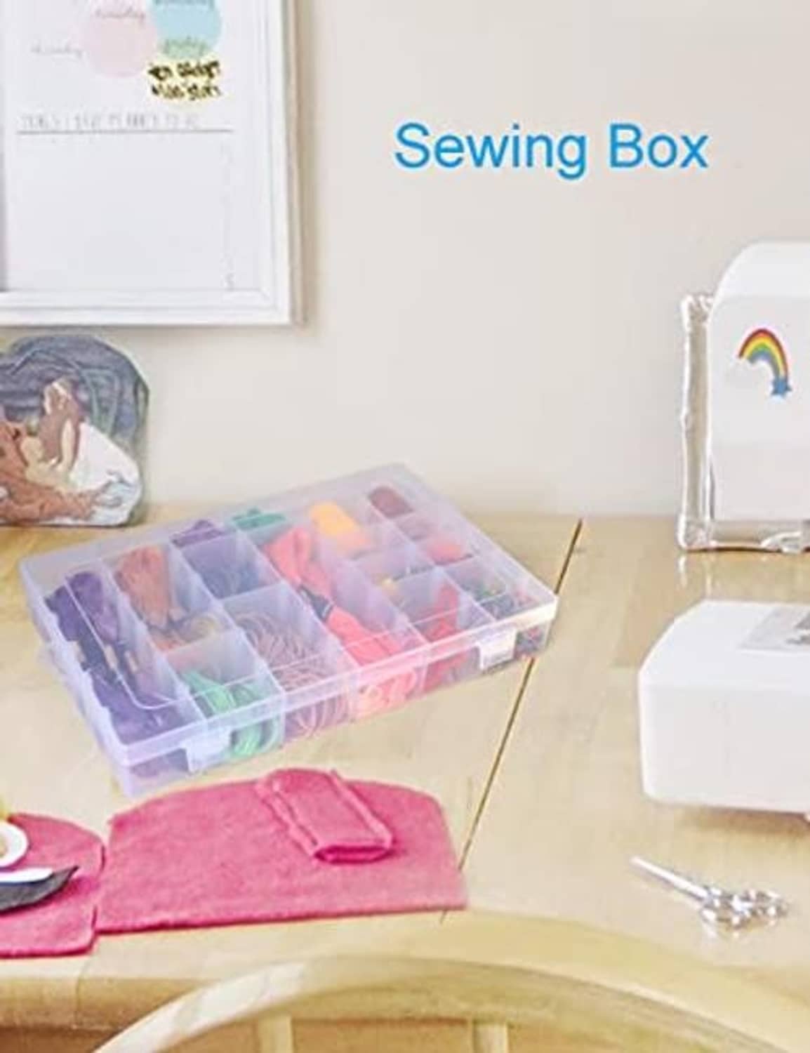 Clear plastic sewing and bead organizer box with lid, open on a tabletop with fabric items
