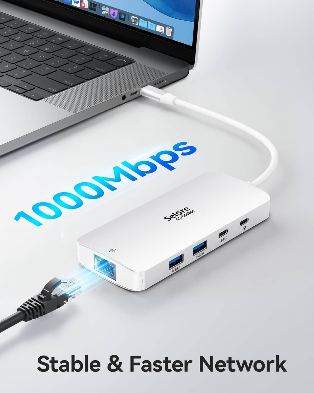 Silver USB-C docking station with LAN and USB ports connected to a laptop