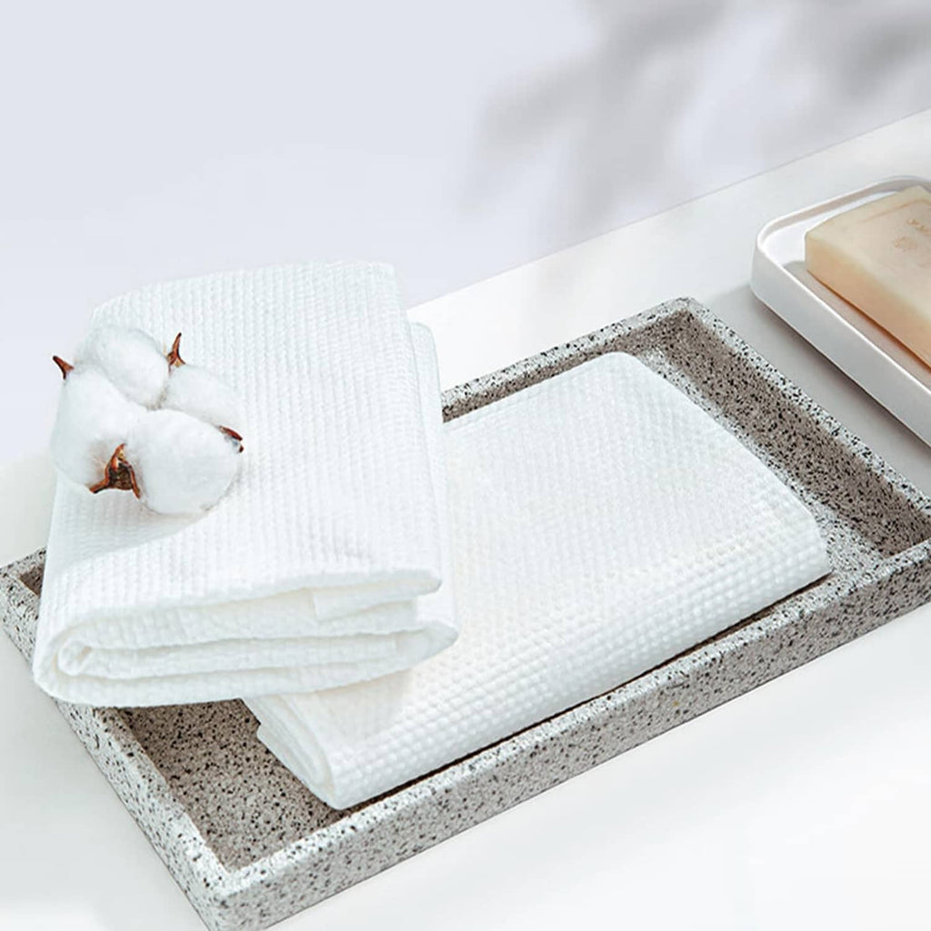 White disposable bath towels, neatly folded in a set for quick use and storage