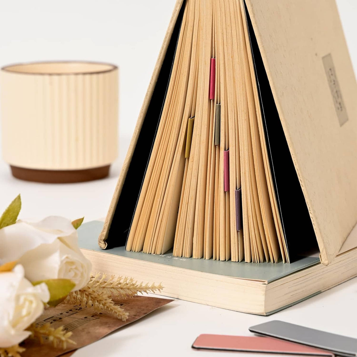Pastel magnetic bookmarks set, slender color tabs on an open book page