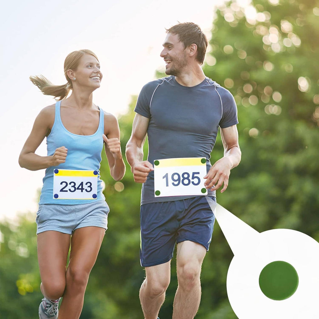 Runners sprinting with race bib numbers fastened using clip-style bib holders