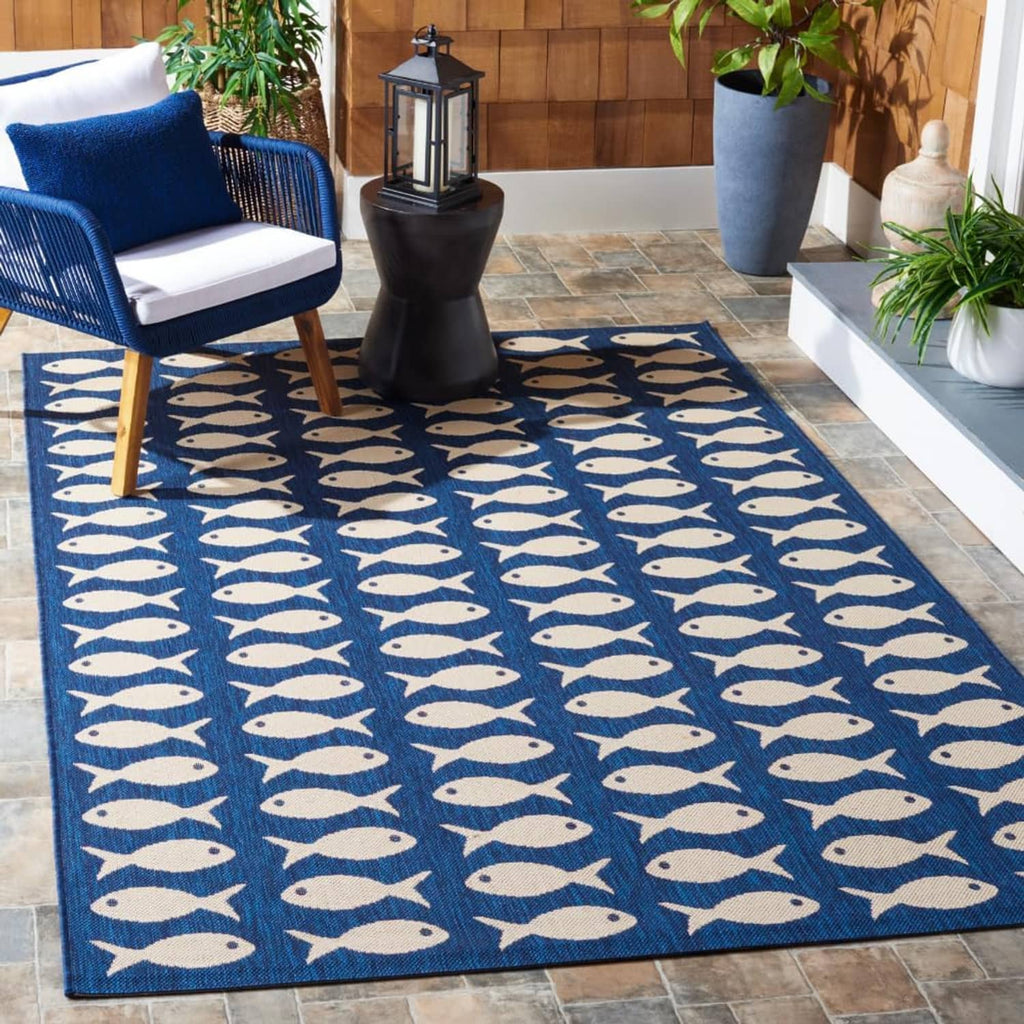 Outdoor washable rug in navy with beige fish motif pattern across the surface.