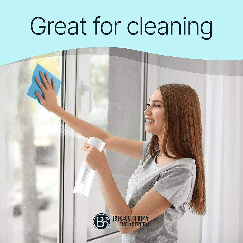 White continuous mist spray bottle spraying onto glass surface for cleaning