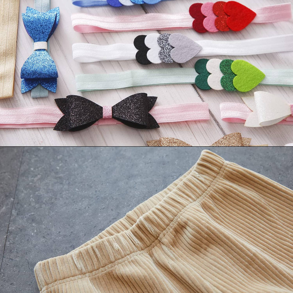 Assorted elastic headbands and bows laid out on a fabric surface