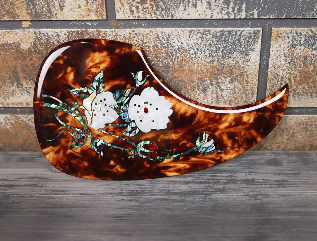 Acoustic guitar pick guard with tortoiseshell finish and white floral abalone inlay
