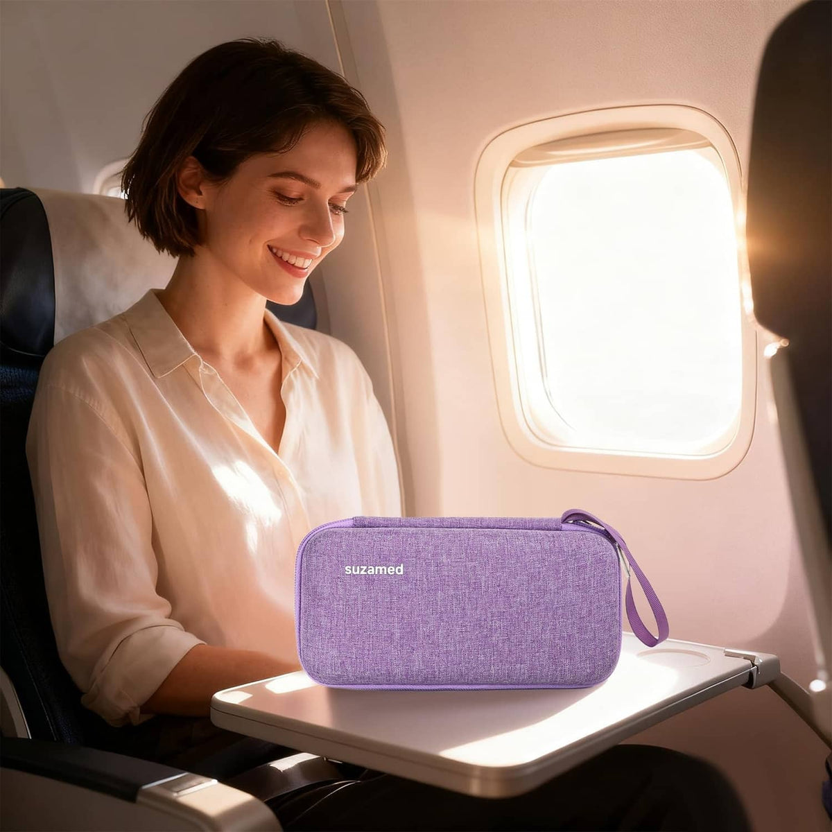 Purple insulin cooler travel case with wrist strap on airplane tray table