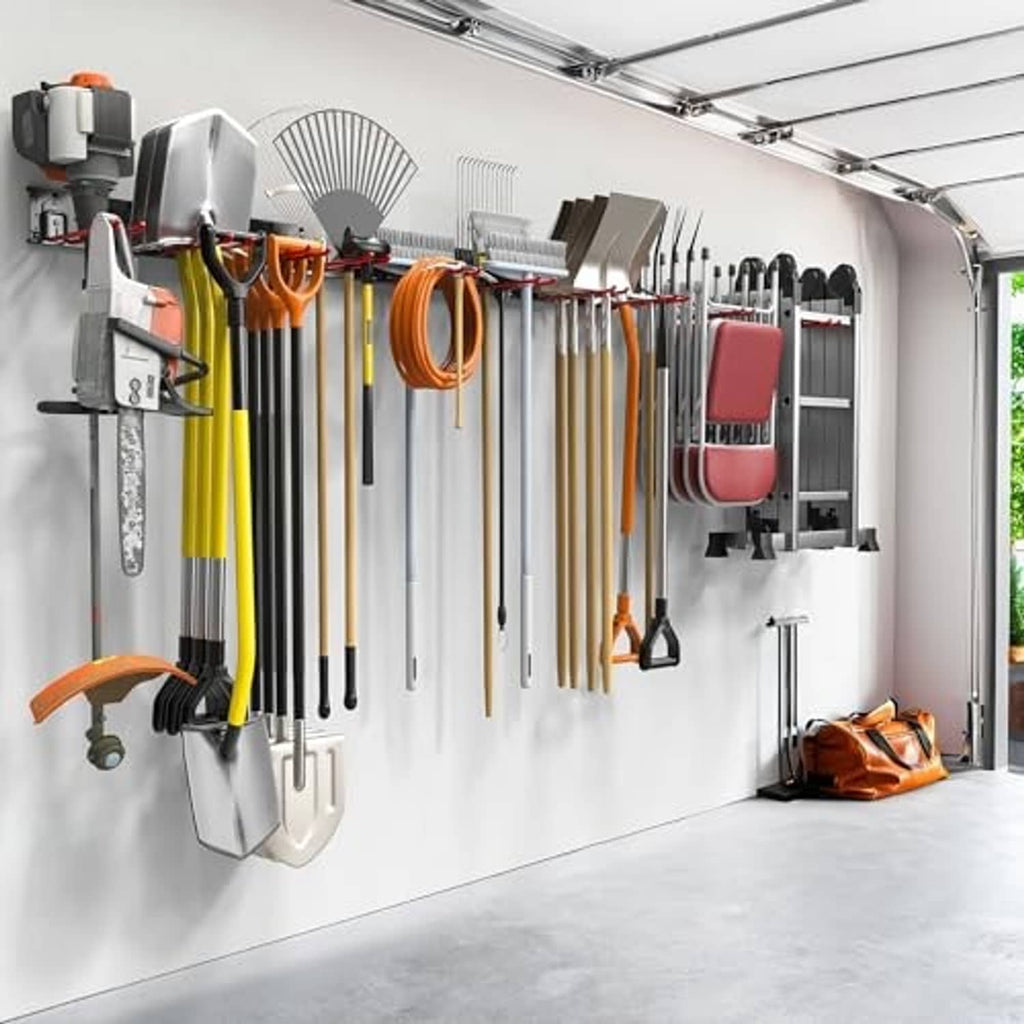 Wall-mounted tool organizer with gray panels and red hooks holding rakes and shovels