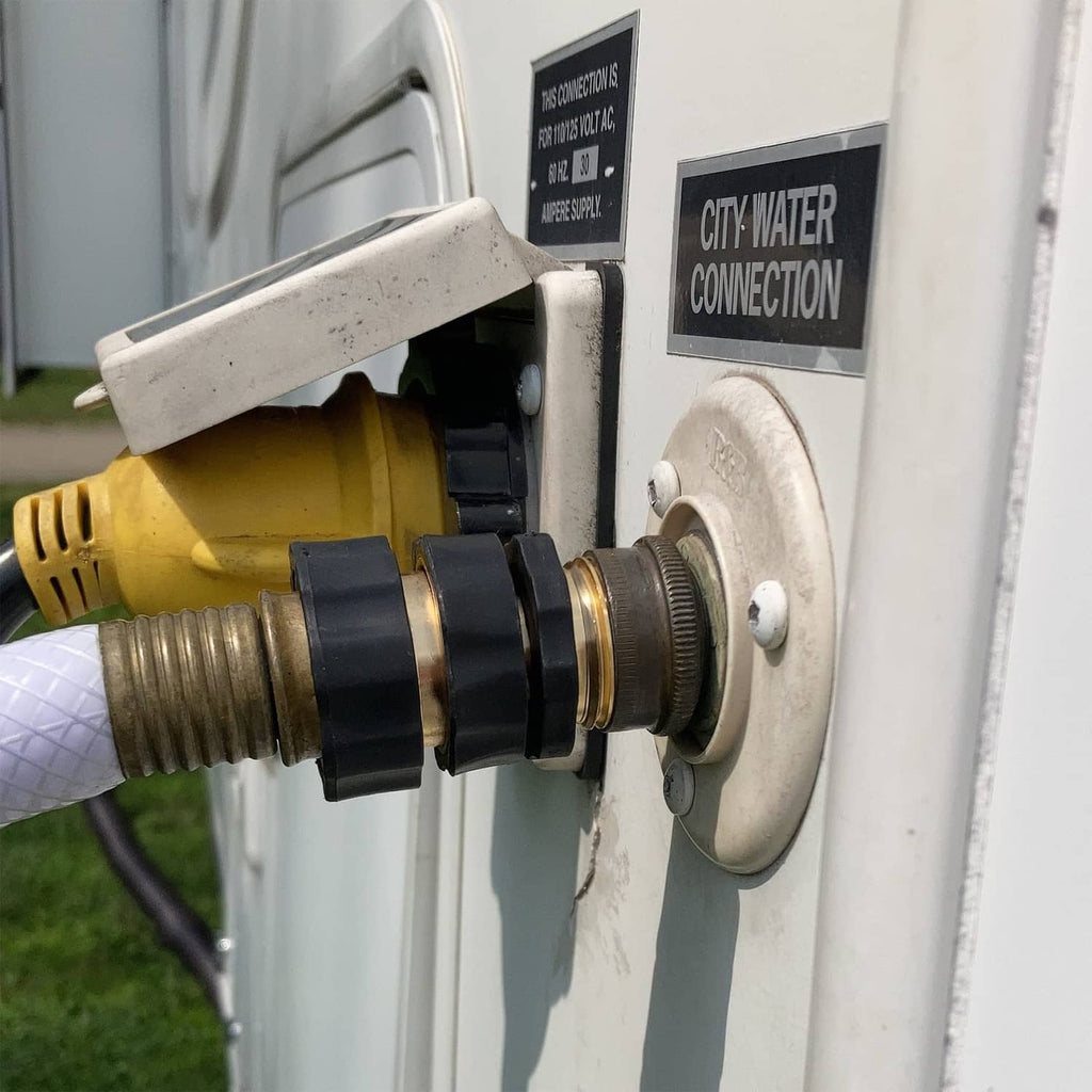 Gold quick connector coupler with black ridged ring on wall-mounted hose inlet