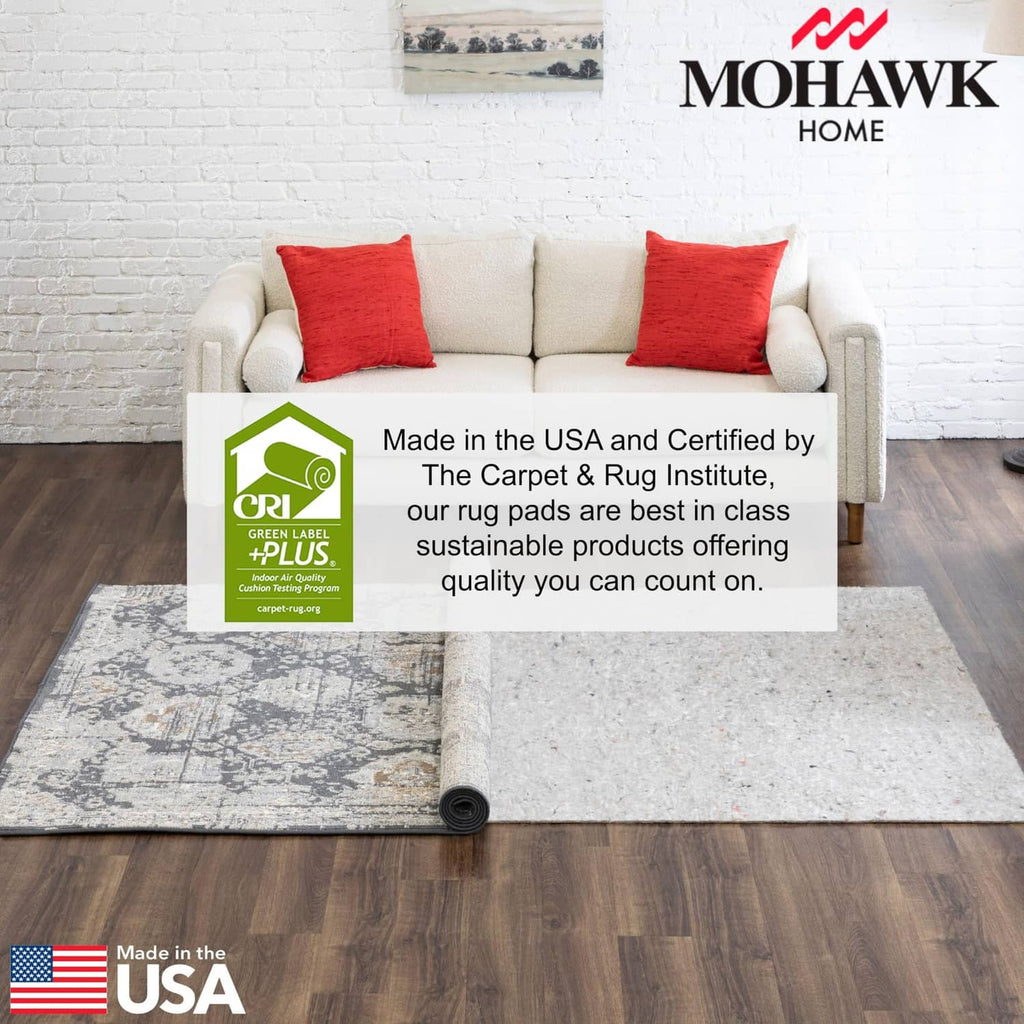 Gray felt rug pad rolled out under a light area rug on hardwood floor