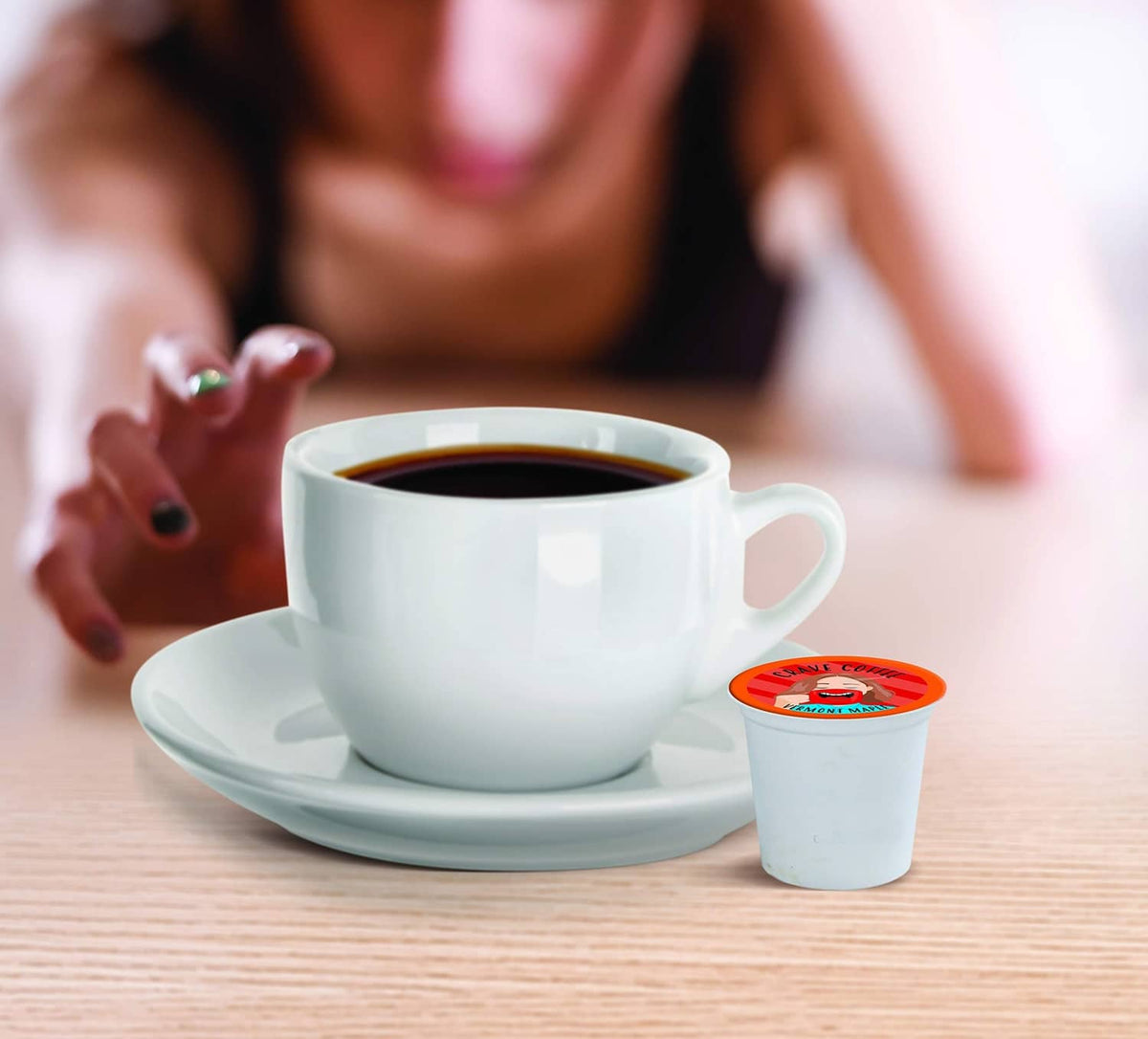 Maple-flavored coffee in white cup with small pod cup beside it