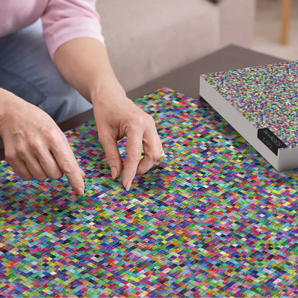 Person assembling a colorful mosaic jigsaw puzzle on a tabletop