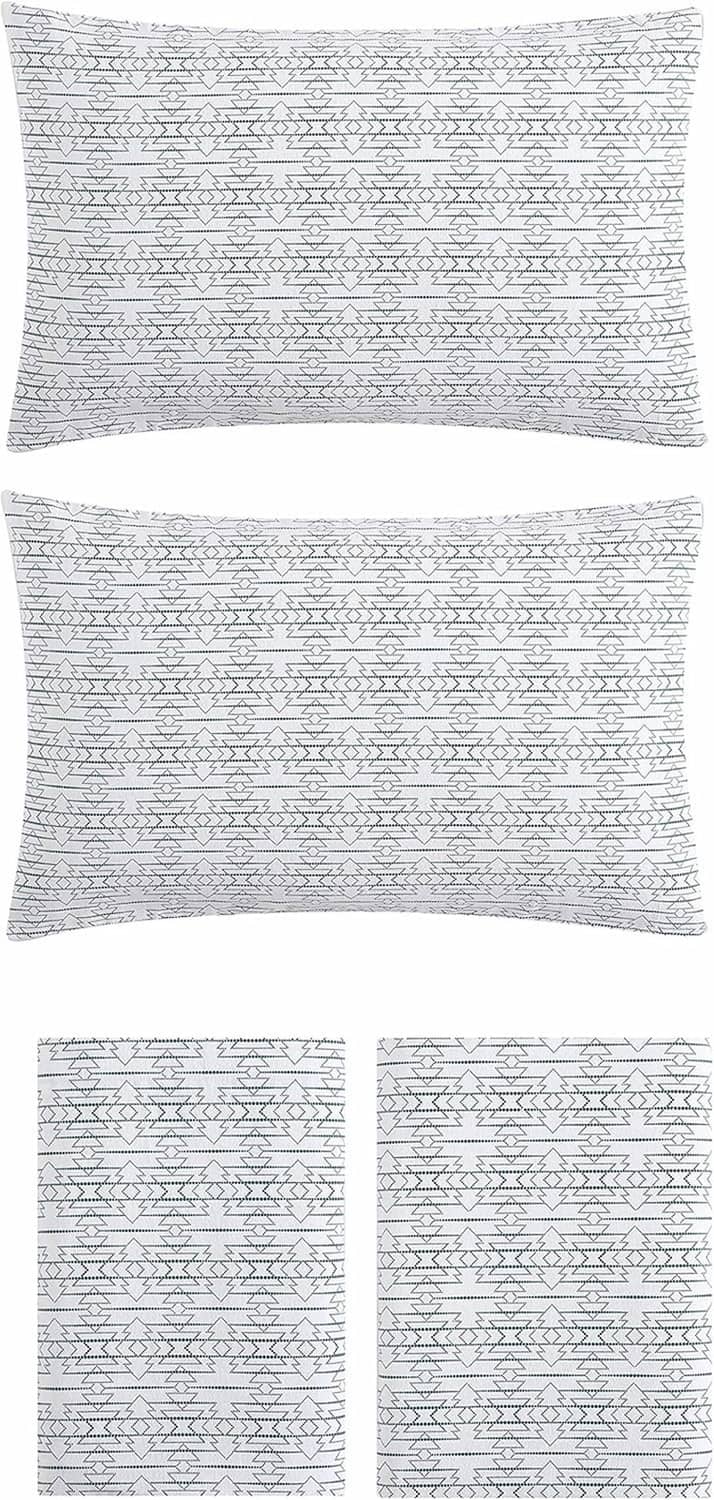 Set of folded white cotton flannel pillowcases with allover navy textural geometric print