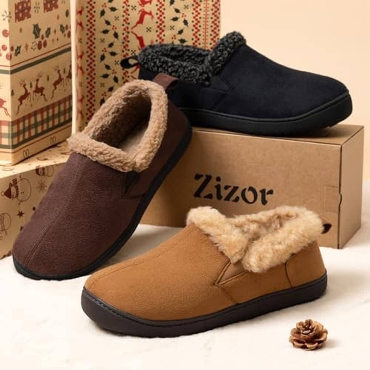 Pair of bootie slippers: black and tan suede with fluffy lining, shown on boxes