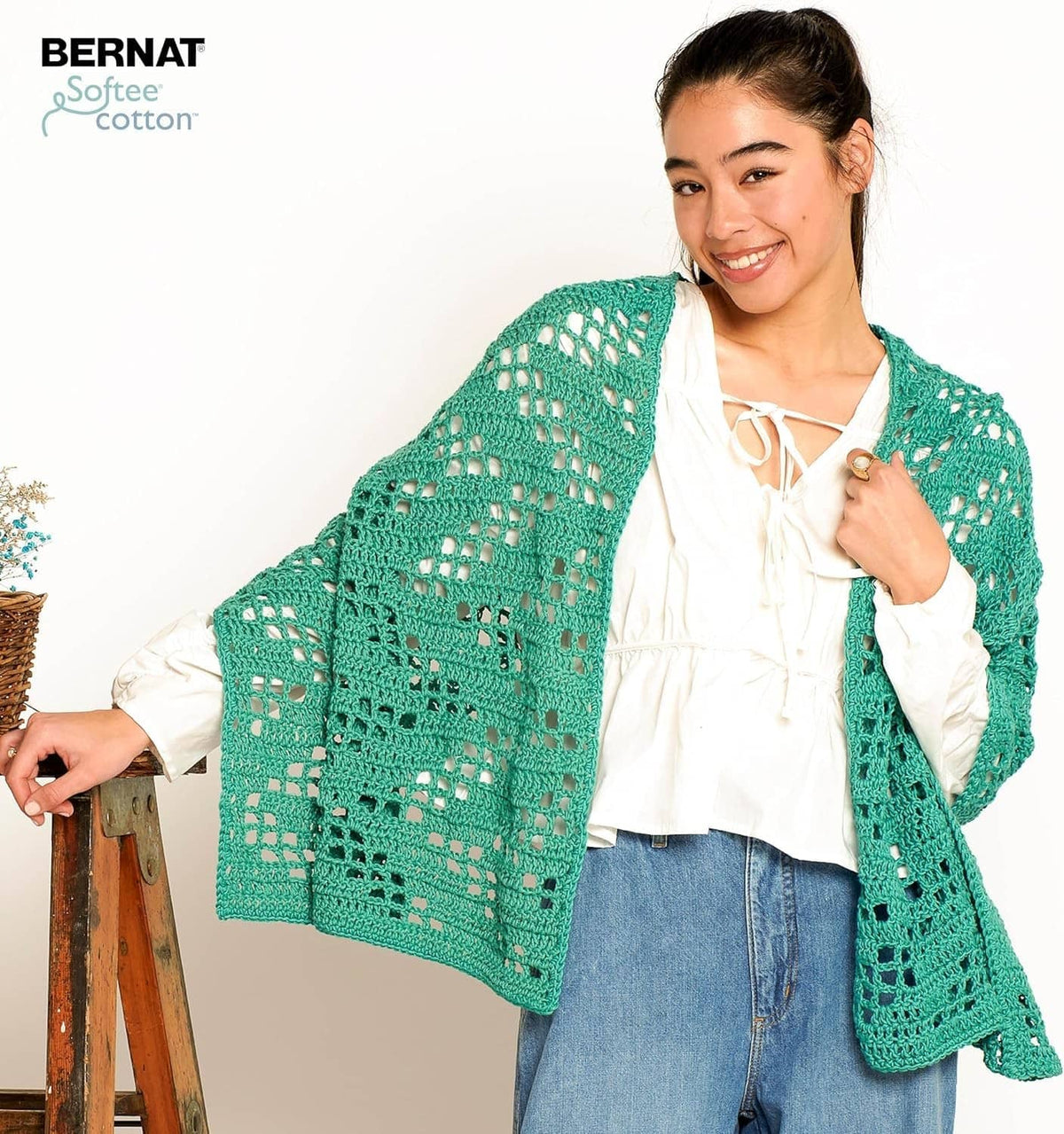 Teal crocheted cardigan with openwork pattern on model