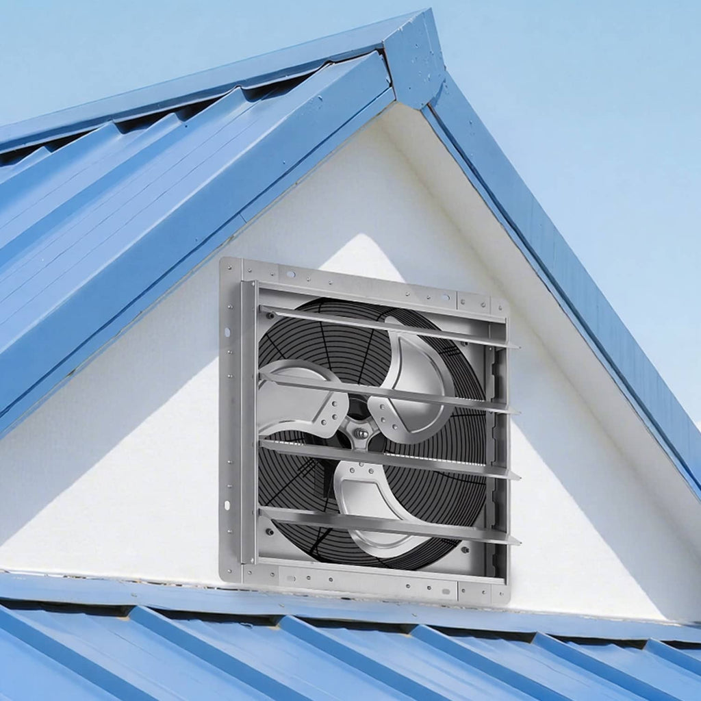 Silver wall-mounted exhaust fan installed in a vented opening with louvers